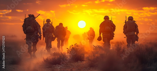 Soldiers in uniform walk into the sunset