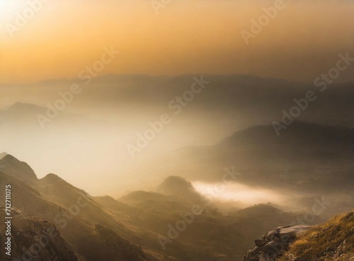 Foggy mountains at sunset, aerial view background