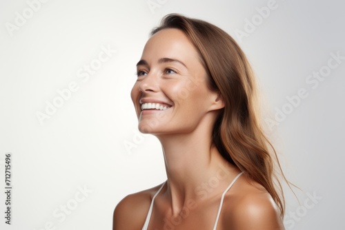Beauty portrait of young smiling woman with clean fresh skin. Studio shot.