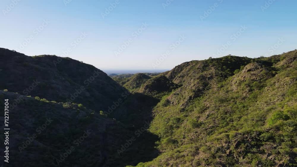 Aerial view of a mountain valley against blue sky Aerial view of a mountain valley against blue sky