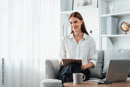 Psychologist woman in clinic office professional portrait with friendly smile feeling inviting for patient to visit the psychologist. The experienced and confident psychologist is utmost specialist