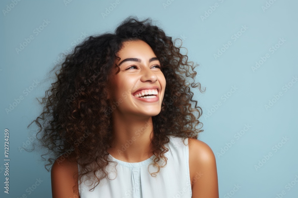 Happy african american woman with curly hair on blue background. Happy african american woman with curly hair on blue background.