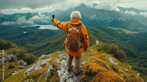 Grandmother taking a photo selfie in the top of a mountain