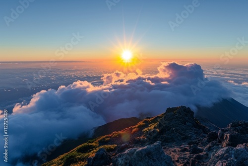 Panorama sunrise from the top of the mount Fuji. The sun is shining strong from the horizon over all the clouds and under the blue sky. good New year new life new beginning. Abstract nature background
