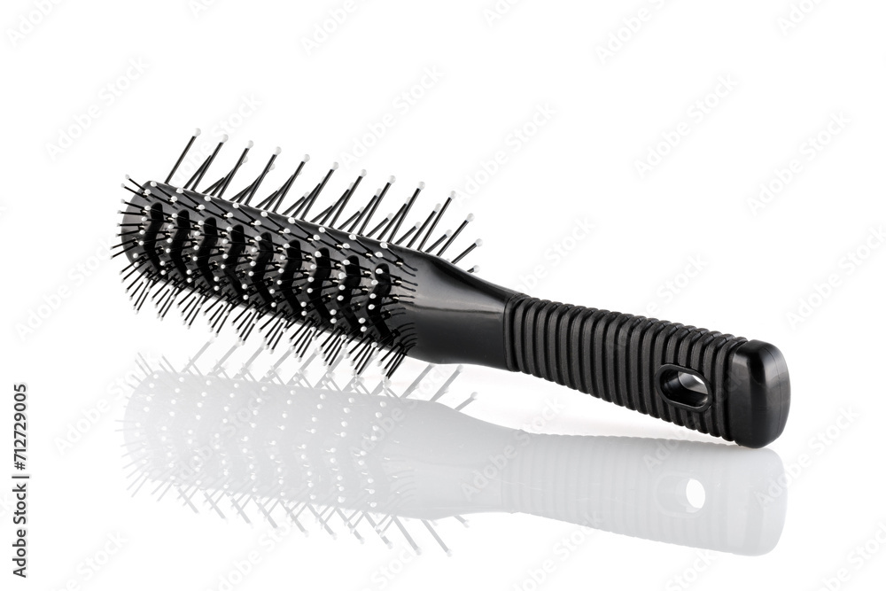 Black double sided hair brush with handle isolated on white background. Combing and hair care, hairdressing tools, haberdashery. Close-up. Black double sided hair brush with handle isolated on white background. Combing and hair care, hairdressing tools, haberdashery. Close-up.