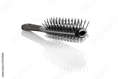 Black double sided hair brush with handle isolated on white background. Combing and hair care  hairdressing tools  haberdashery. Close-up.
