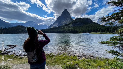 Woman Hiking around Swiftcurrent Lake in Many Glacier Region of Glacier National Park photo