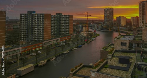 Calandkade 100, 2521 AA Den Haag, Netherlands - December 23, 2023: Golden sunset in the dormitory area of Hague. Zoom out animation. photo