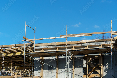 An outdoor construction site. Construction of a new building. Block construction, reinforced concrete beams and wooden floors and roofs. © Pokoman