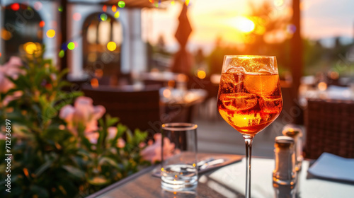 Aperol Spritz cocktail on summer restaurant patio  sunset