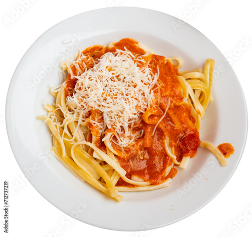 Delicious noodles Bolognese served with grated parmesan in a plate. Isolated over white background