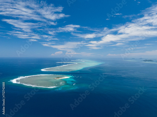 View of island and sea surrounded by coral reef
