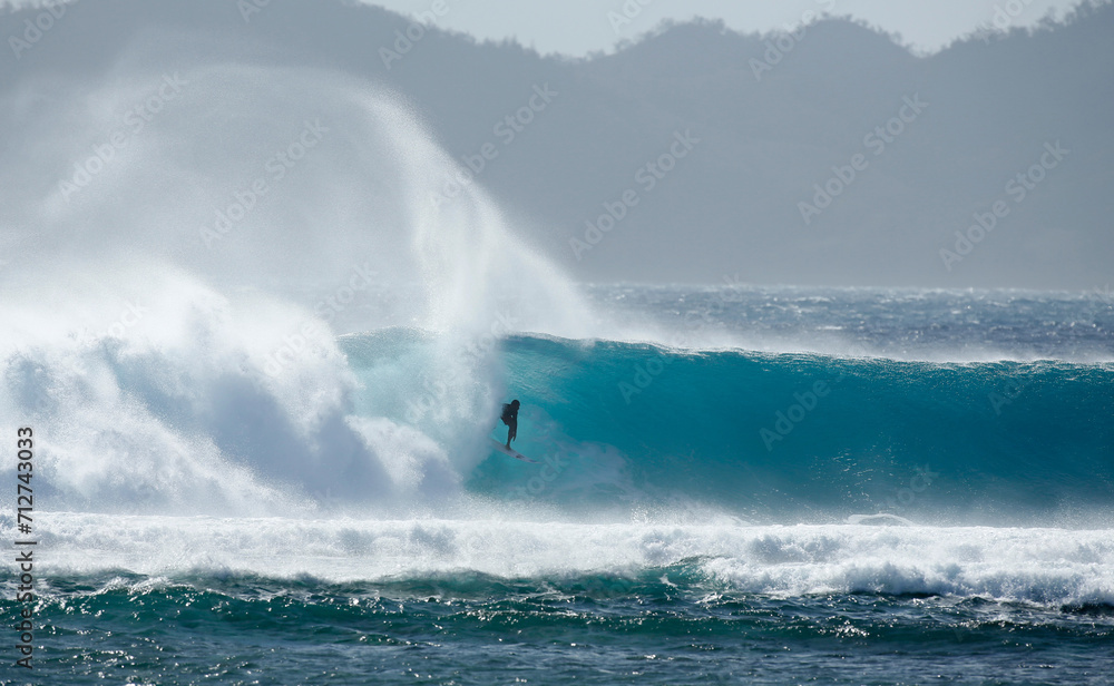 Surfer on a wave in Fiji 