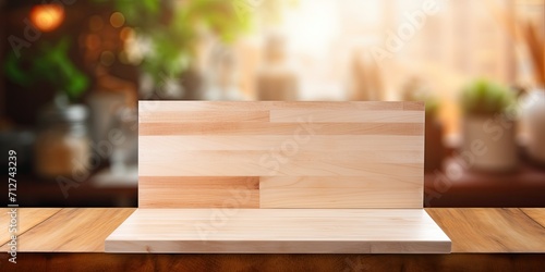 Empty wooden board on a blurred kitchen background - for showcasing or assembling products.