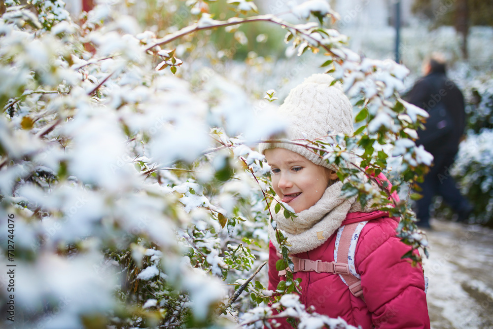 Adorable preschooler girl having fun in beautiful winter park on a snowy cold winter day Adorable preschooler girl having fun in beautiful winter park on a snowy cold winter day