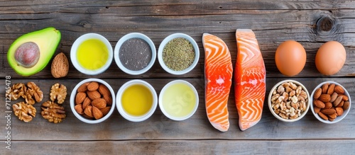 Omega 3 rich food options: almonds, pecans, walnuts, olive oil, fish oil, salmon, flax seeds, chia, eggs, and avocado. photo