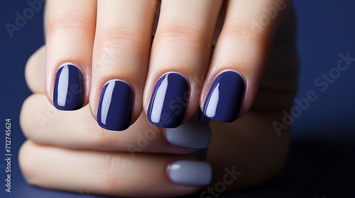 Glamorous woman with navy blue gel polish in luxury salon for elegant nail art and french manicure.