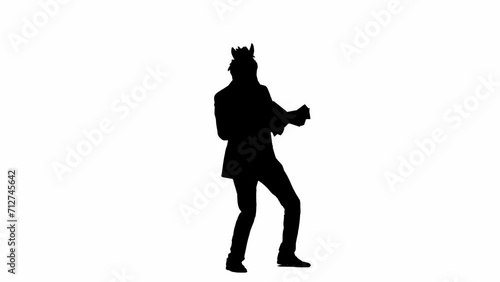 Black silhouette of man in business suit with horse head mask on white isolated studio background. A businessman is looking through documants and dancing merrily. Concept of hard office work. photo
