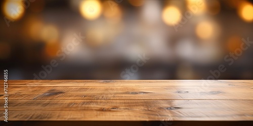 Wooden table surface with blurred background - suitable for displaying or showcasing products.