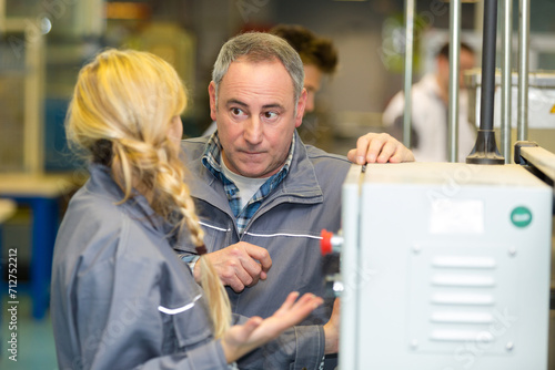Obraz na plátně supervisor reprimanding worker stood at machinery controls