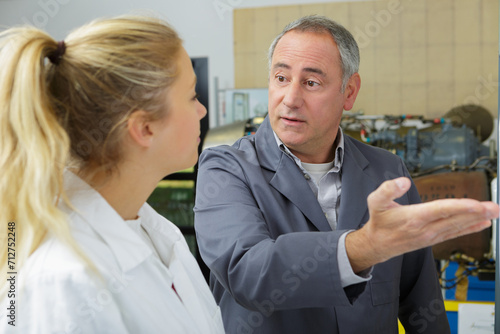 man and woman talking about repairing aircraft