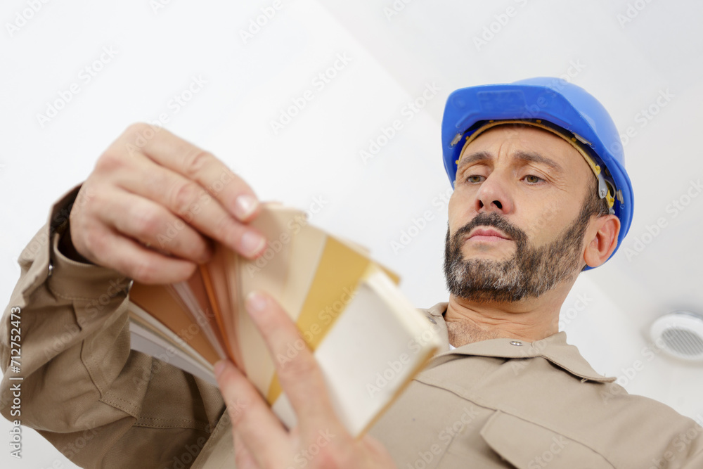 a painter holding color swatches a painter holding color swatches