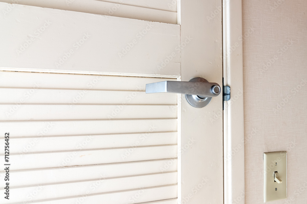 metal door handle on a white wooden door.Door handles elements close up. metal door handle on a white wooden door.Door handles elements close up.