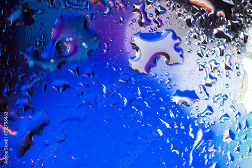 Obraz na plátně colorful light and water drops on glass, breathtaking view created by light and water