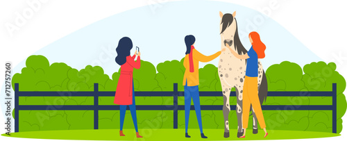 Two women petting a horse in a fenced grassy area, one woman taking a photo. Friends enjoying time with a horse outdoors. Countryside leisure activity vector illustration.