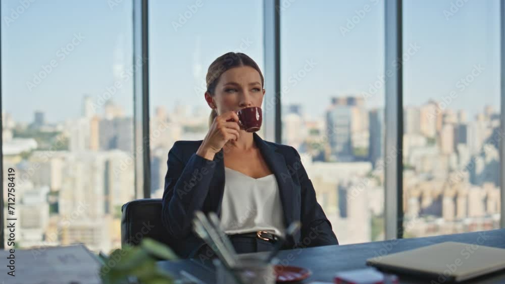Calm manager drinking coffee in modern office. Smiling woman enjoying break Calm manager drinking coffee in modern office. Smiling woman enjoying break