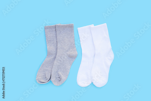 Grey and white socks on blue background.