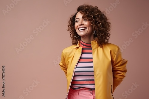 Portrait of a beautiful young woman in yellow jacket and pink pants
