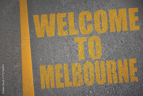 asphalt road with text welcome to melbourne near yellow line.