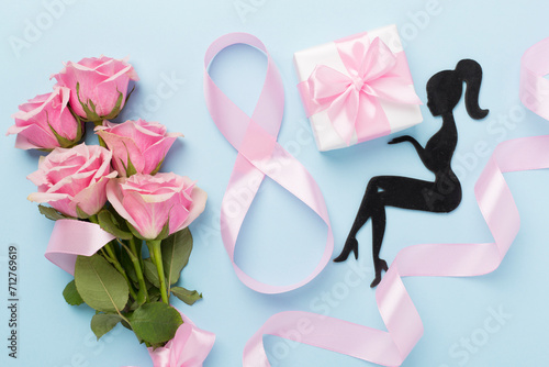Composition with pink roses, gift box and eight made of ribbon on color background, top view. Women's day concept © Liami