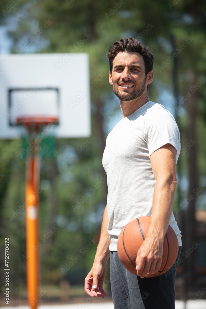 handsome male playing basketball outdoor