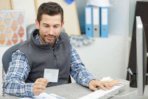 man on laptop looking at samples