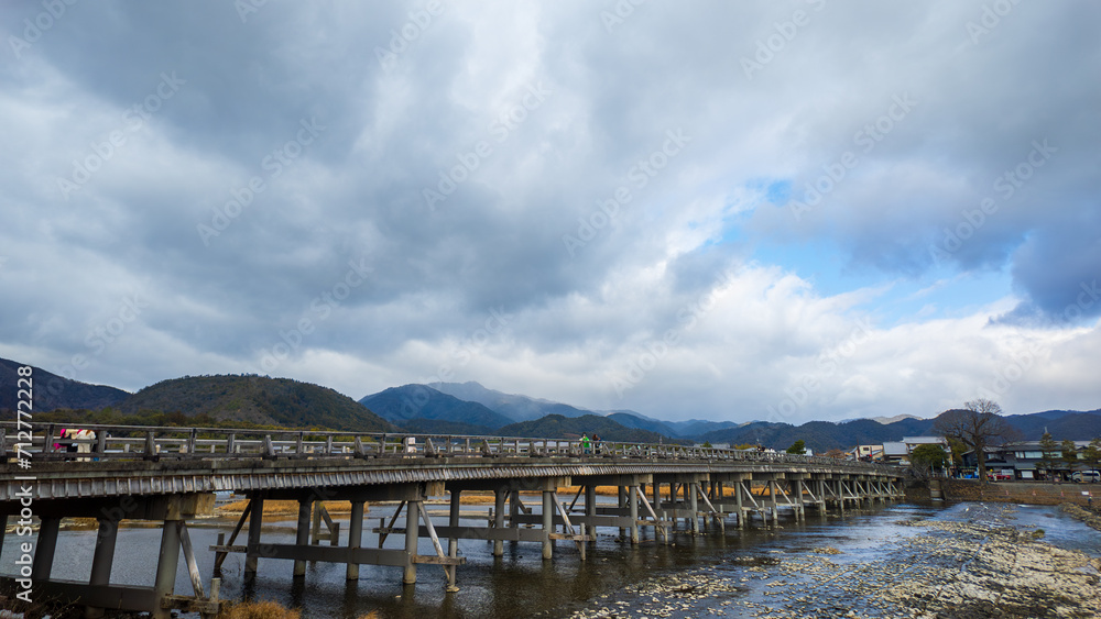 Historic wooden bridge crosses river to Arashiyama in Kyoto, Japan Historic wooden bridge crosses river to Arashiyama in Kyoto, Japan