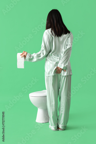 Young woman in pajamas with...