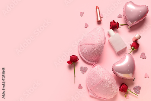 Composition with stylish female bra, cosmetics, balloons and rose flowers on pink background. Valentine's Day celebration