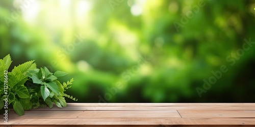 Green garden and house background with empty wooden table for product display montage.
