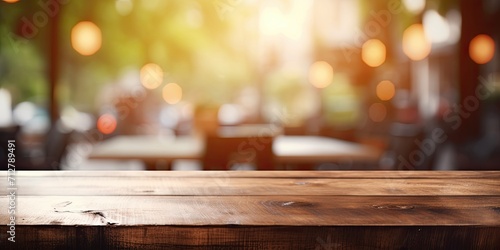 Wooden table with blurred cafe background for displaying or creating product montages.