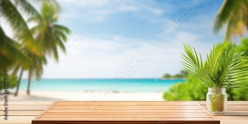 Mock up template displaying design with wooden table top and blurred tropical forest backdrop including green palm leaves  sky  and sea.