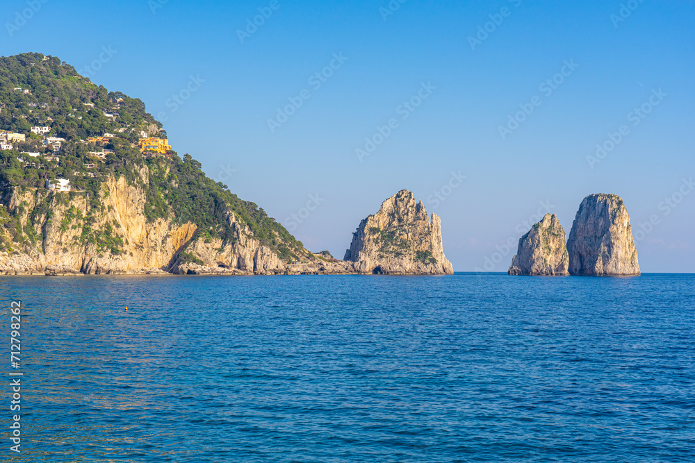 Naklejka premium beautiful cliffs by the beach of the small marina .Island of Capri, Naples, Italy