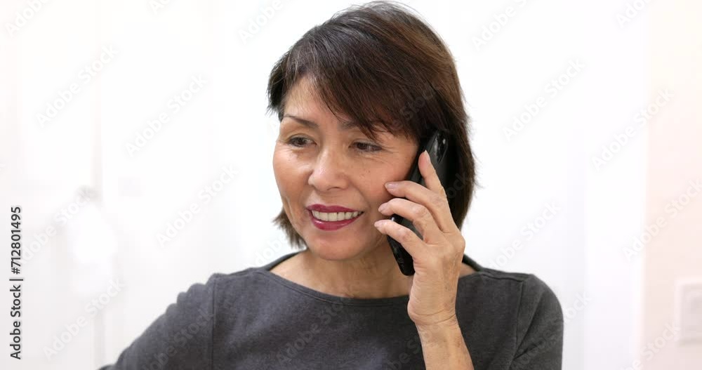 Portrait attractive happy woman looking at camera smiling talking on mobile phone isolated with white background closeup.