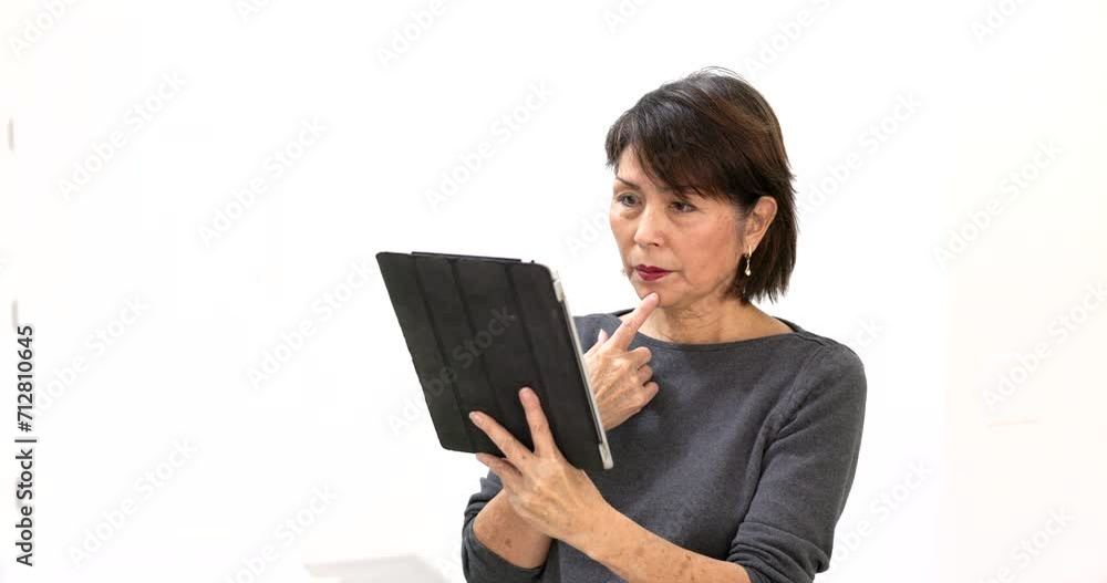 Attractive stylish woman pretty face enjoying reading texting email messages on mobile tablet relaxing isolated in bright room. Attractive stylish woman pretty face enjoying reading texting email messages on mobile tablet relaxing isolated in bright room.