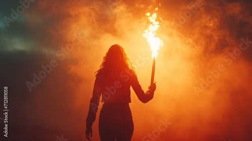 A powerful image of a woman holding a torch, representing leadership, knowledge, and enlightenment.