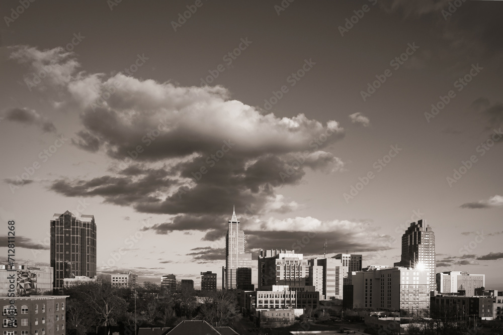 A dramatic city skyline of downtown Raleigh, North Carolina in the United States in black and white.
