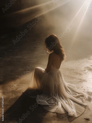Contemplative Woman in Elegant White Dress Bathed in Sunrays in a Dramatic Atmospheric Setting