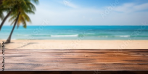 Empty wood table with blurred beach background - ready for product display. © Sona