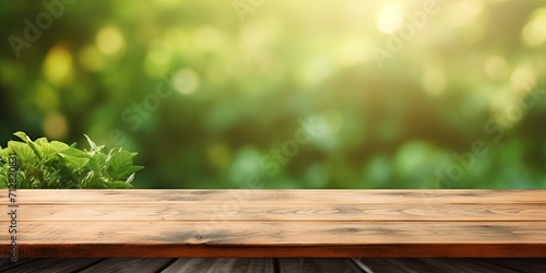Wooden table with green abstract blur for product display or garden mockup.